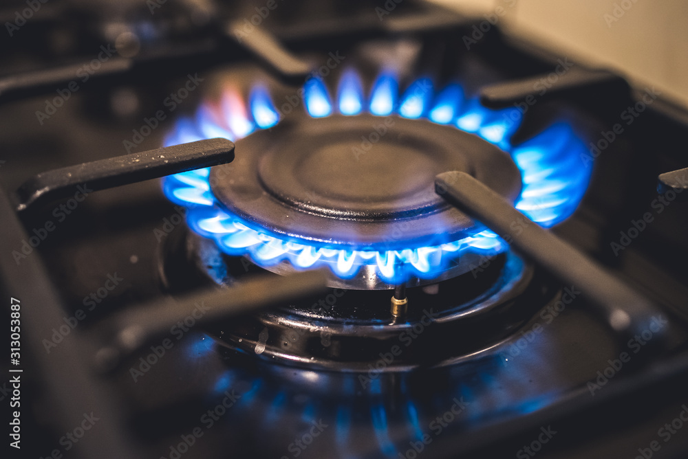 Kitchen stove cook. Kitchen gas cooker with burning blueflames fire propane gas.