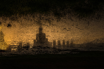 Wall Mural - Shadow in the water of Ancient Buddha Statue at Sukhothai historical park, Mahathat Temple, Thailand. UNESCO World Heritage Site in Thailand.