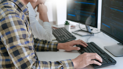 pensive programmer working on desktop pc programming code technologies or website design at office s