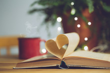 Love Reading Or Saint Valentine's Day Background. Open Book With A Heart Shape Page. Knowledge, Education Or Love Concept