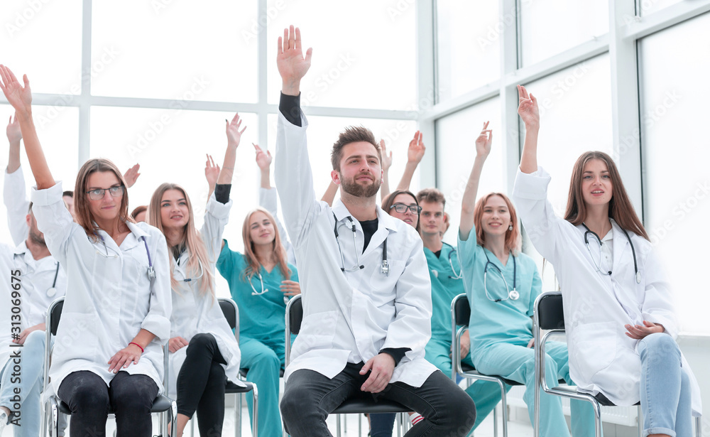 medical students raising their hands during the seminar. - obrazy, fototapety, plakaty 