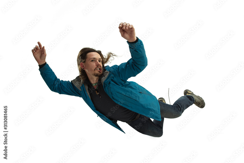A second before falling. Caucasian young man falling down in moment with bright emotions and facial expression. Male model in casual clothes on white. Shocked, scared, screaming. Copyspace for ad. - obrazy, fototapety, plakaty 