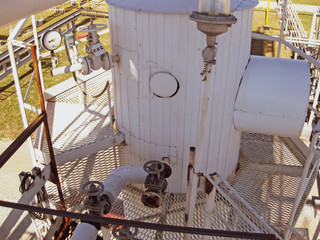 Technological columns of oil refinery.