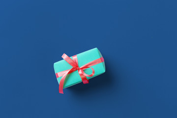 Wall Mural - Gift box on classic blue background top view