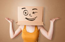 Pretty Woman Standing And Gesturing With A Carton Box On Her Head