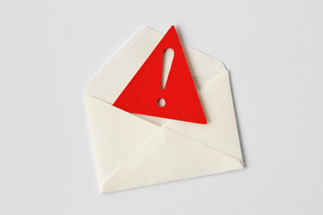 Email envelope with warning sign on white background