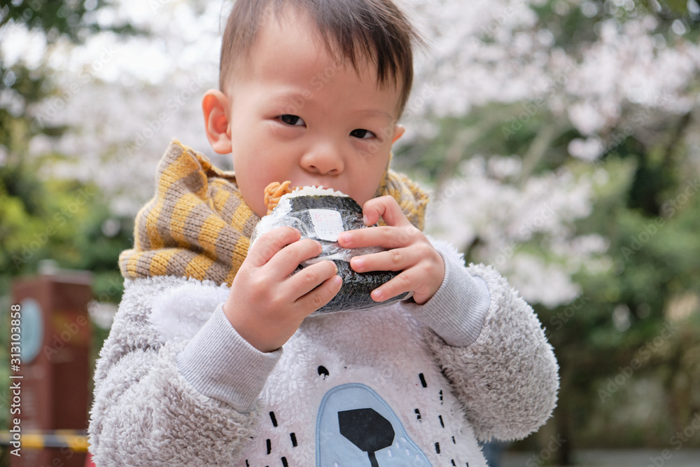 Asian toddler boy biting & eating Onigiri, Japanese food, Japanese rice ...