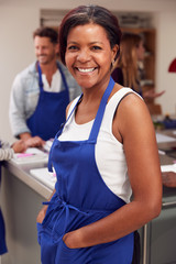 Wall Mural - Portrait Of Smiling Mature Woman Wearing Apron Taking Part In Cookery Class In Kitchen