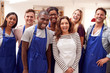 © Monkey Business - Portrait Of Smiling Group Of Students Wearing Aprons Taking Part In Cookery Class In Kitchen