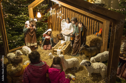 Photographie Czestochowa, Poland, January 1, 2020: Children in front of the Christmas stable