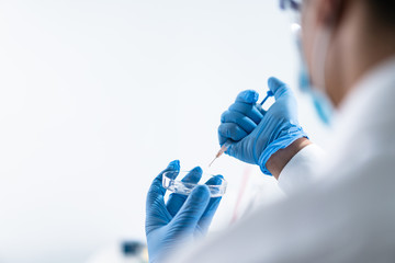 man holding test tube with fluid, making laboratory research