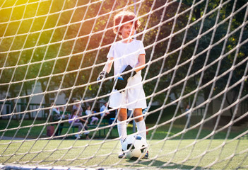 Wall Mural - Summer soccer tournament for young kids. football club. emotions and joy of the game. Young goalie. Kids - soccer champion. Boy goalkeeper in football sportswear on stadium with ball. Sport concept.