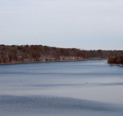 The peaceful lake on a cold autumn snowy day.