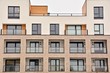 © Grand Warszawski - Modern apartment buildings on a sunny day with a blue sky. Facade of a modern apartment building.