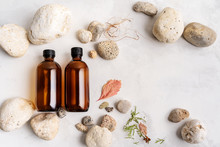 Flat Lay Composition With Two Brown Glass Bottles Over Natural Background Of Real Tree Bark, Moss On Light Stone Surface With Copy Space For Mockup Of Body Care Organic Cosmetics.