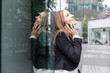 © Westend61 - Smiling businesswoman on the phone in the city