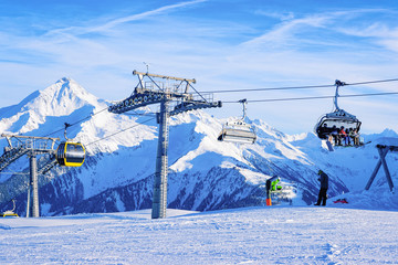 Canvas Print - Cable cars and chair lifts in Penken park ski resort in Tyrol in Mayrhofen in Zillertal valley, Austria, winter Alps. Alpine mountains with white snow, blue sky. Downhill fun at Austrian snowy slopes