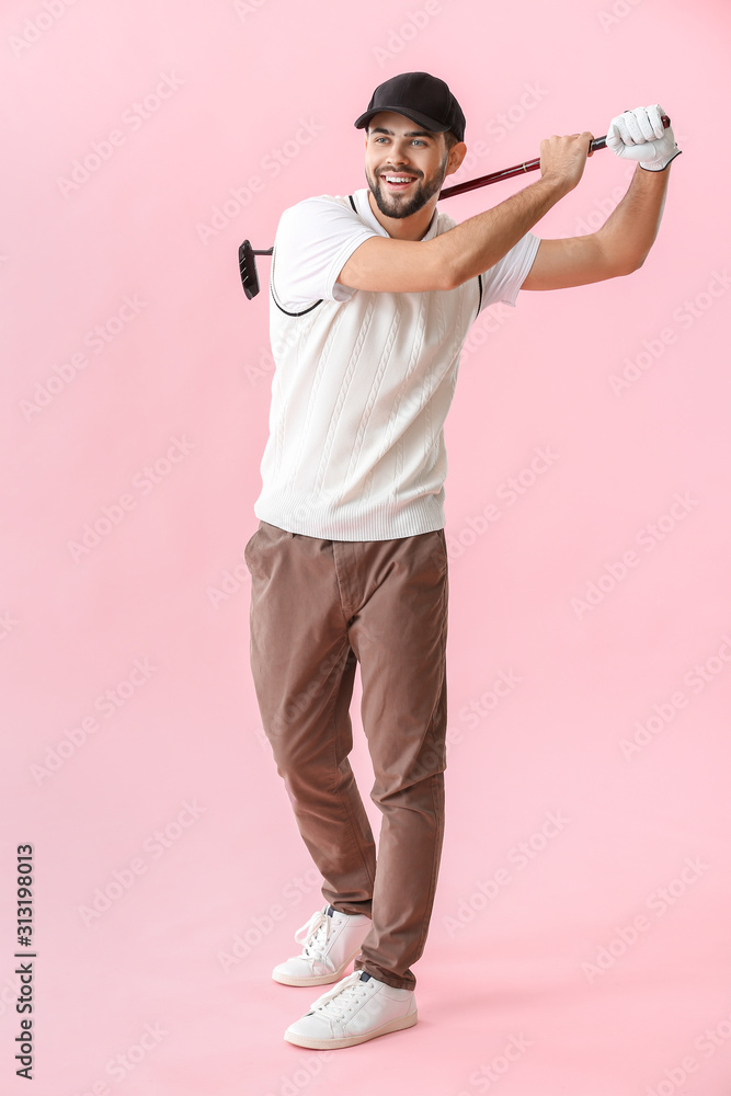 Handsome male golfer on color background
