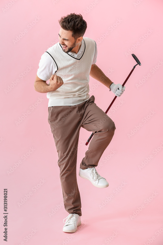 Handsome happy male golfer on color background