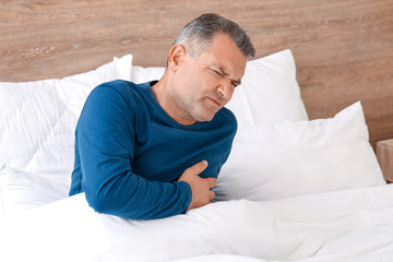 Poster - Mature man suffering from heart attack in bedroom