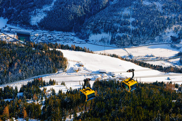 Canvas Print - Cable cars at Penken park ski resort at Tyrol in Mayrhofen in Zillertal valley, Austria in winter Alps. Chair lifts in Alpine mountains with white snow, blue sky. Downhill fun at Austrian snowy slopes