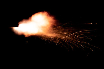 Wall Mural - the texture of a shot from a firearm on a black background, the output of gunpowder gases from the barrel of a rifle and a pistol