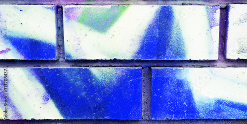 White brick wall painted with acrylic multicolored paint for background