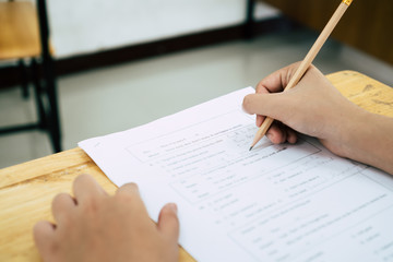 Wall Mural - english exams test student in school, university students holding pencil for testing exam writing an