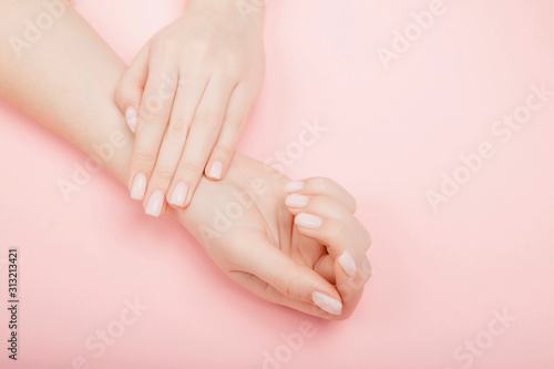 Fotografering Stylish trendy manicure nail young woman hands on pink background, top view