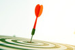 © Eakrin - Close up red color arrow in the center of Bullseye concept of business goal and capability.