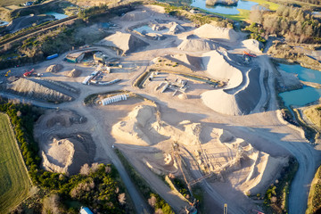 Wall Mural - Quarry works industrial digging aerial view from above showing sand mound and hills