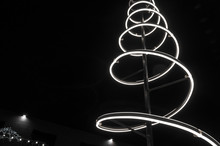 Monochrome Photo. Christmas Installation. Spiral Of Light, Black Night Sky.