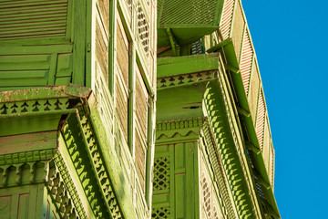 Wall Mural - Close-up view of the greenish Noorwali coral town house at the Souk al Alawi Street in the historic city center of Al Balad, Jeddah, Saudi Arabia