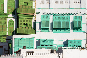 View of the famous greenish Noorwali coral town house at the Souk al Alawi Street in the historic city center of Al Balad, Jeddah, Saudi Arabia