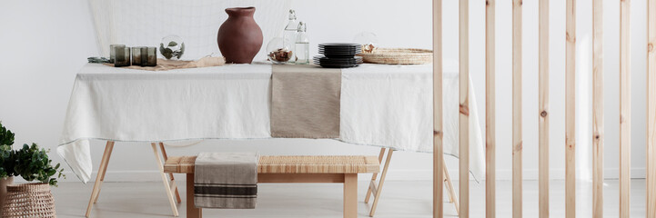 Wall Mural - white linen tablecloth and clay jug on the table in natural eco dining room
