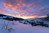 Fototapeta Do pokoju - mountainous countryside in winter at dawn. snow covered hills and fields of carpathian rural area rolling off in to the distant krasna ridge. glowing fog in the valley. colorful clouds on the sky