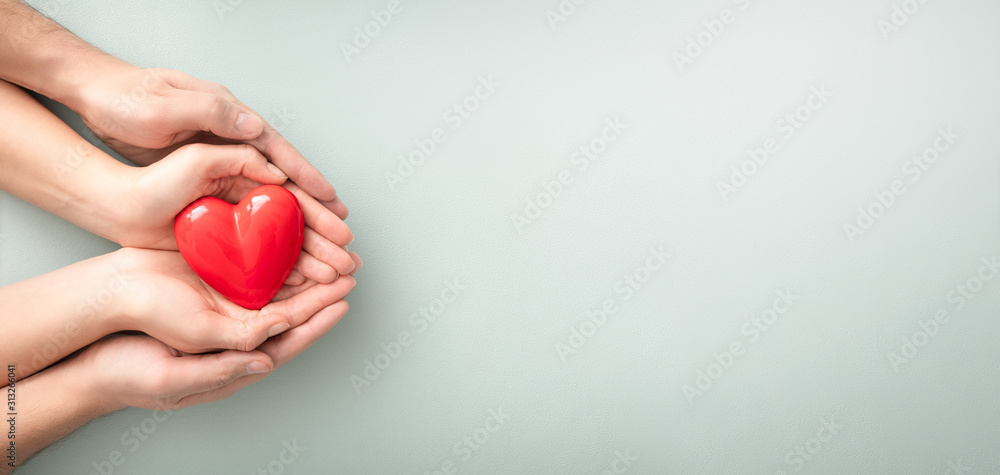 The adult and the child holding red heart. - obrazy, fototapety, plakaty 