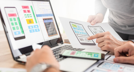 designers drawing website ux app development.