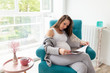 © Impact Photography - Pregnant woman reading a magazine and drinking tea