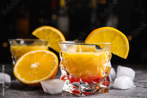 Cuadros en Lienzo Fresh alcoholic Tequila Sunrise cocktail on grey table