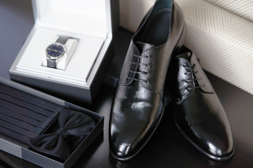 Groom wedding set with shoes wristwatch bow tie, close-up