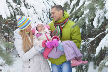 Poster - Happy family at beautiful sunny winter day outdoor in nature