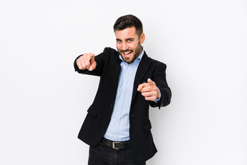 Wall Mural - Young caucasian business man against a white background isolated cheerful smiles pointing to front.