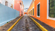 Cobblestone street and colorful houses in city centre of Old San Juan, Puerto Rico.