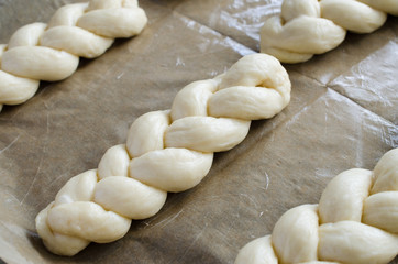 Wall Mural - Preparation process - raw unbaked buns. Homemade traditional pigtail buns on baking paper.