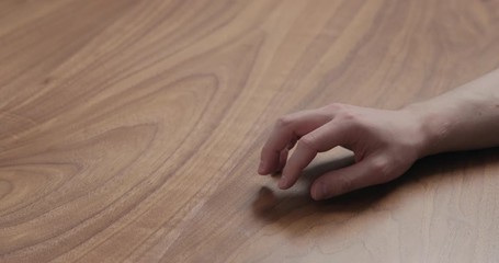 Canvas Print - Slow motion man hand finger tapping on black walnut table