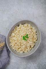 Wall Mural - Bowl of cooked Whole grain brown rice  on wooden background overhead view