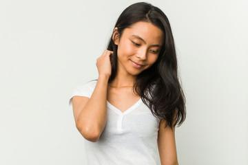 Wall Mural - Young chinese woman posing on a white background