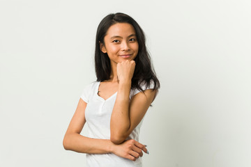 Wall Mural - Young chinese woman posing on a white background