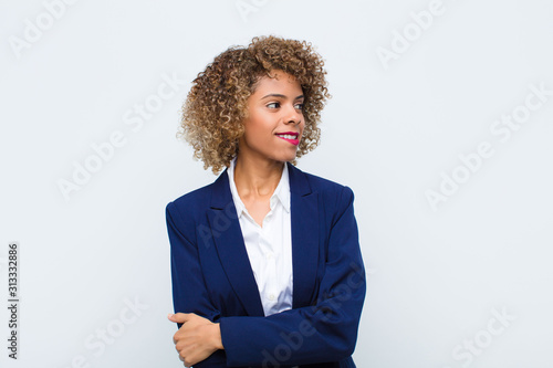 Cuadros en Lienzo young woman african american doubting or thinking, biting lip and feeling insecu
